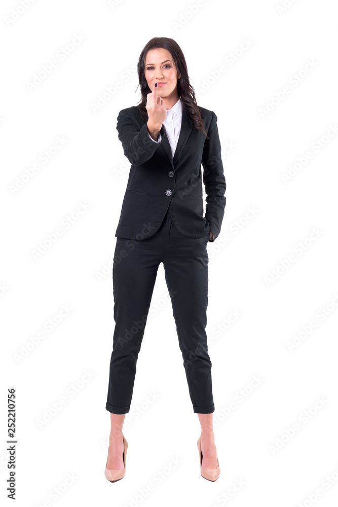 Angry annoyed business female showing middle finger gesture at camera with evil smile. Full body isolated on white background. Angry annoyed business female showing middle finger gesture at camera with evil smile. Full body isolated on white background.