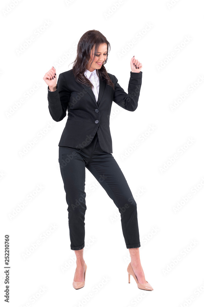 Relaxed cheerful business woman dancing with arms up while looking down. Full body isolated on white background. Relaxed cheerful business woman dancing with arms up while looking down. Full body isolated on white background.