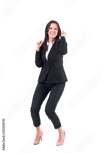 Excited cheerful businesswoman winner celebrating with clenched fists. Full body isolated on white background. 