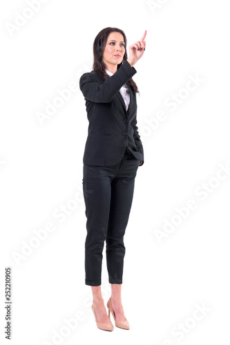 Elegant confident business woman pushing button with finger on interactive vr screen. Full body isolated on white background. 