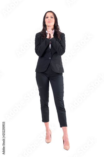 Female business manager with fingers under chin and clasped hands analyzing giving opinion. Full body isolated on white background. 
