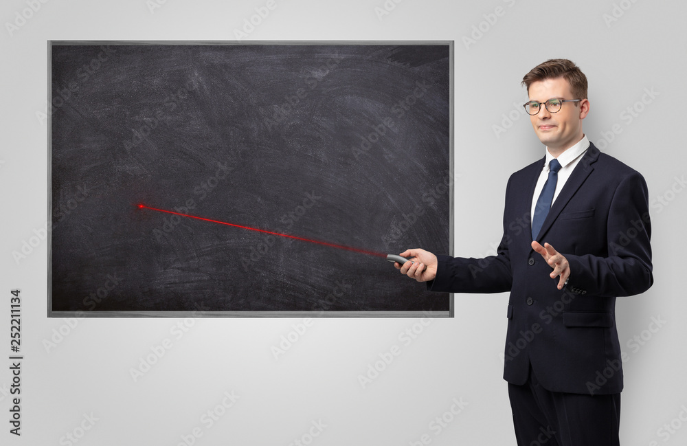 Handsome young teacher with laser pointer teaching 
