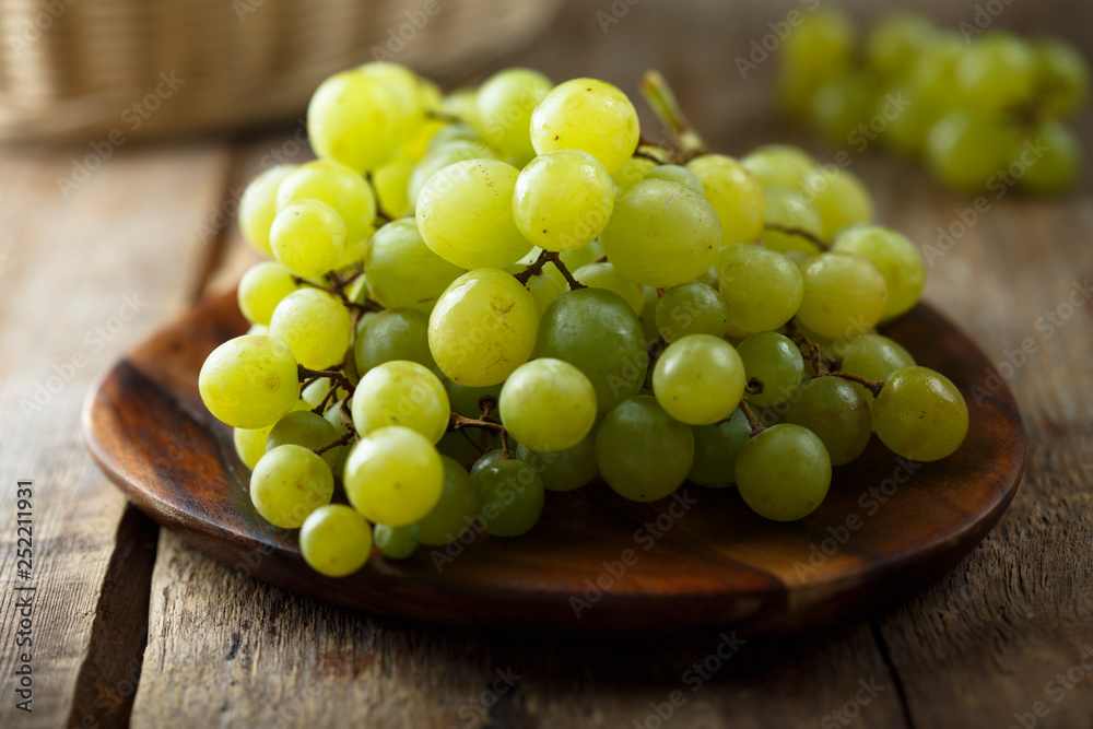 Ripe white grape on wooden desk Ripe white grape on wooden desk