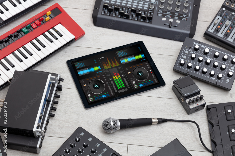 Mixing music on tablet with electronic music instruments concept
Mixing music on tablet with electronic music instruments concept