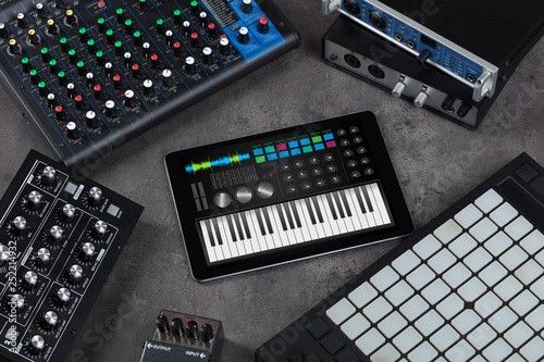 Piano synthesizer app on tablet and musical instrument concept 
