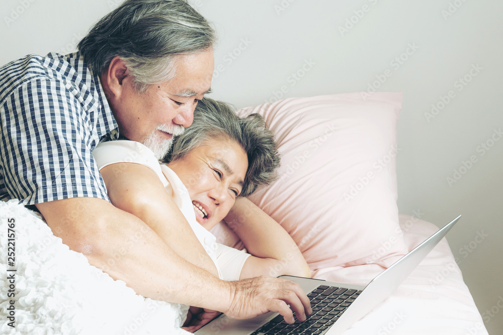 senior couple happy love Elderly couple smile face, old man and senior woman relaxing in bed room playing a laptop computer in the morning - lifestyle senior concept senior couple happy love Elderly couple smile face, old man and senior woman relaxing in bed room playing a laptop computer in the morning - lifestyle senior concept