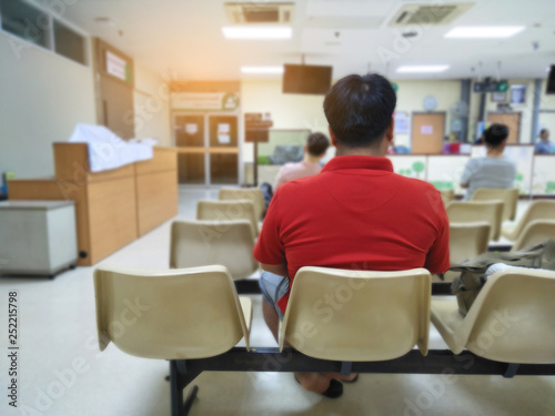 adult man and many people waiting medical and health services to the hospital,patients waiting treatment at the hospital,blurred image of people