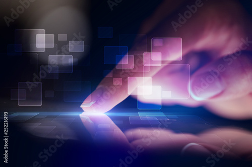 Finger touching tablet with identification concept and dark background photo