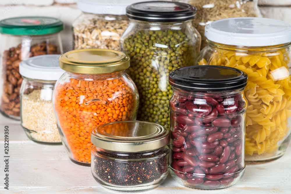 Cereals, Legumes, and beans in glass jars on white kitchen table. Cereals, Legumes, and beans in glass jars on white kitchen table.