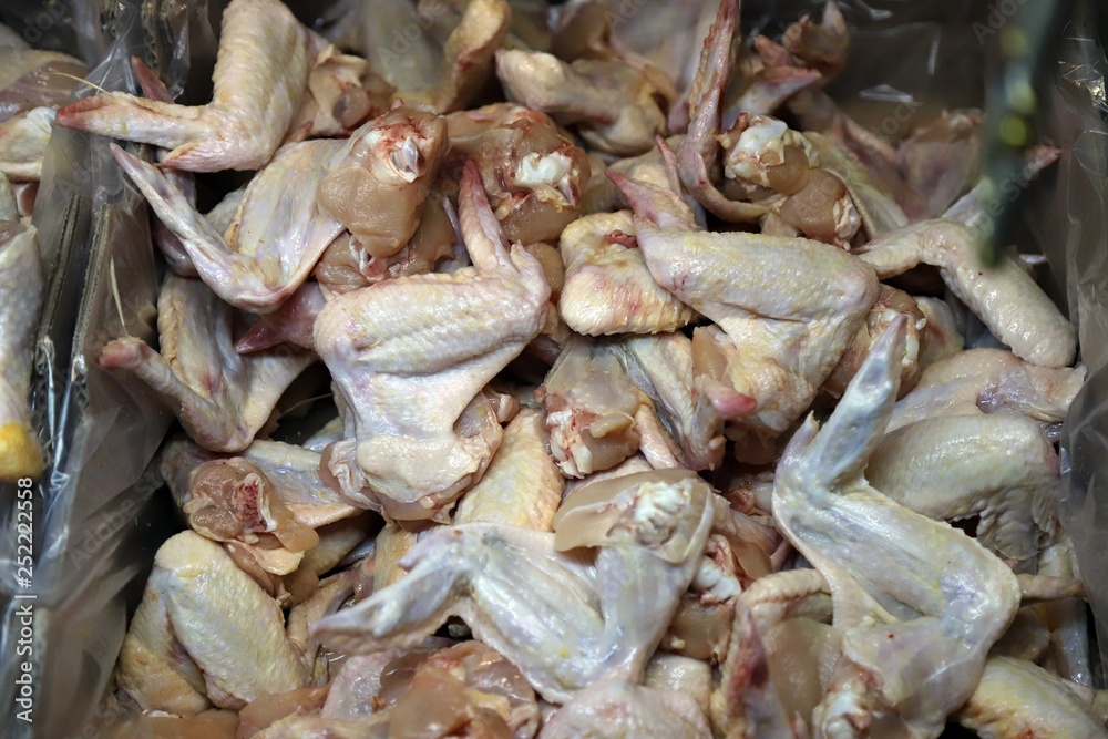 Preparation of chicken wings on chopping board finishing.turkey -