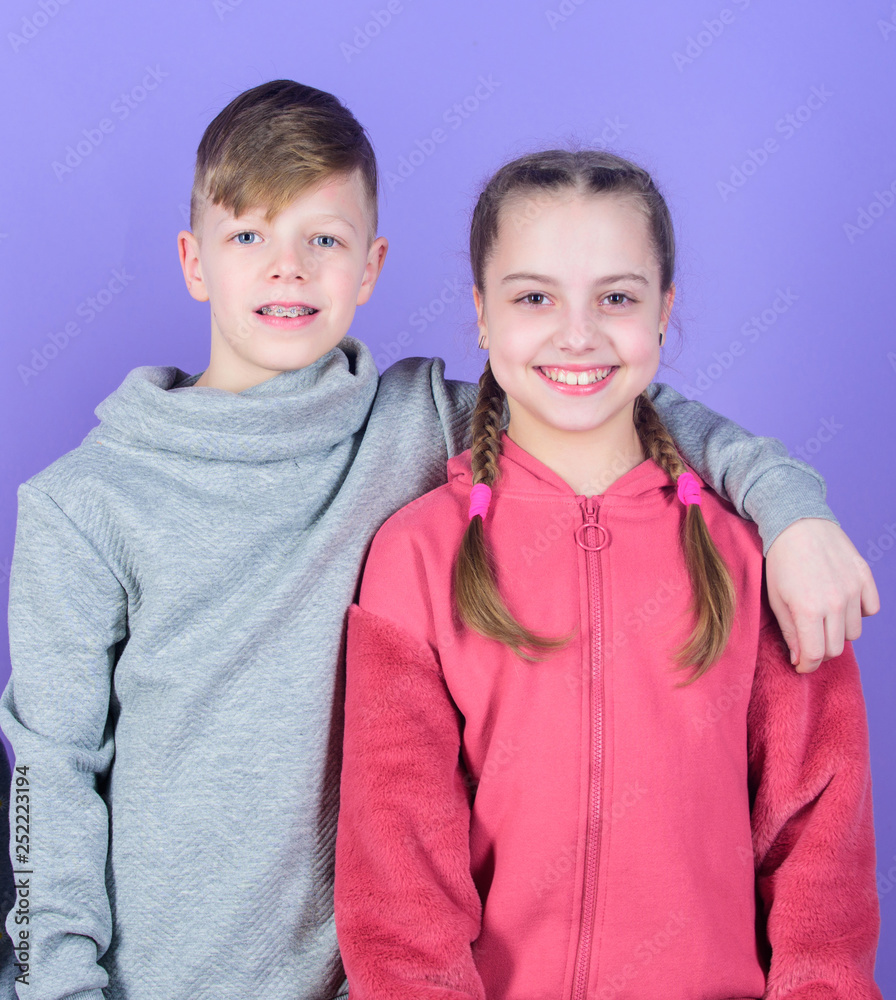 Teens friends. Girl and boy true friendship. Children smiling faces on violet background. Friends hug. Childrens day. Cheerful youth. Relations and friendship. Happy to have such good friends