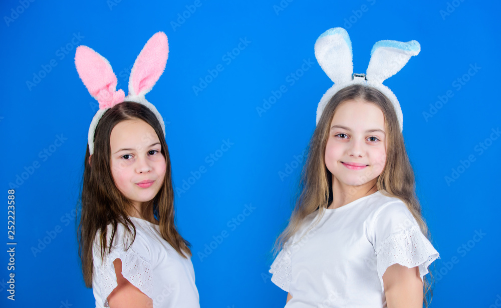 Dressing is a style of life. Fashionable small girls in Easter style. Cute children wearing bunny style headbands for Easter part. Easter fashion style for kids Dressing is a style of life. Fashionable small girls in Easter style. Cute children wearing bunny style headbands for Easter part. Easter fashion style for kids