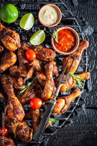 Hot and spicy roasted chicken wings on metal grate