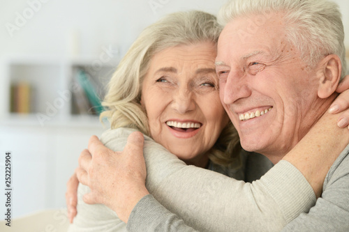 Portrait of cute happy senior couple posing at home