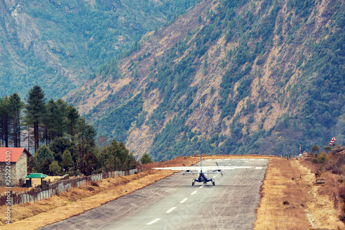 Lukla airport. In the frame of the airport runway and taking off the plane. Nepal. Everest trekking. photo