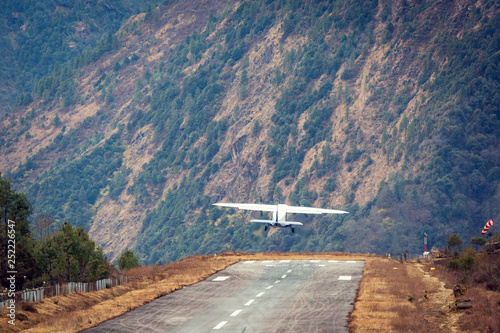 Lukla airport. In the frame of the airport runway and taking off the plane. Nepal. Everest trekking. photo