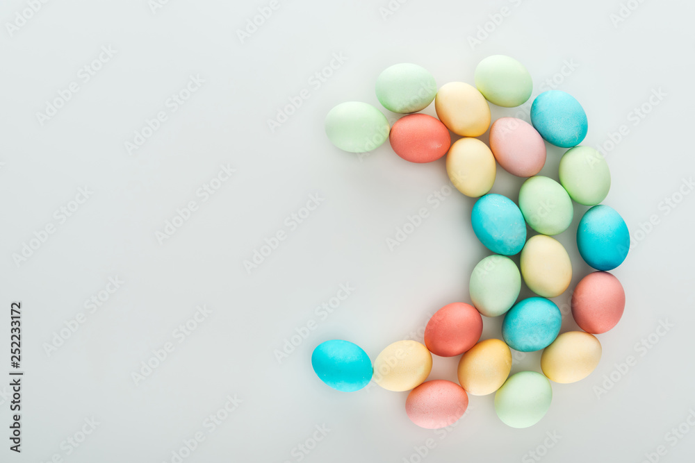 top view of pastel colorful easter eggs isolated on grey