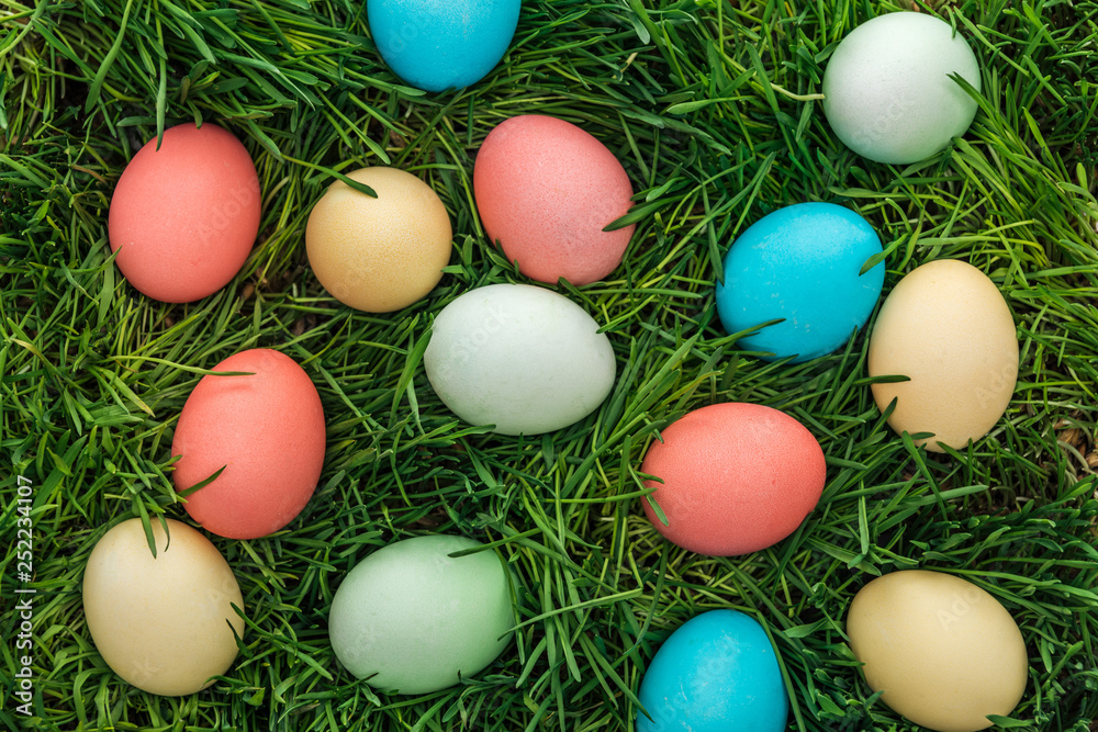top view of traditional colorful easter eggs on green grass top view of traditional colorful easter eggs on green grass