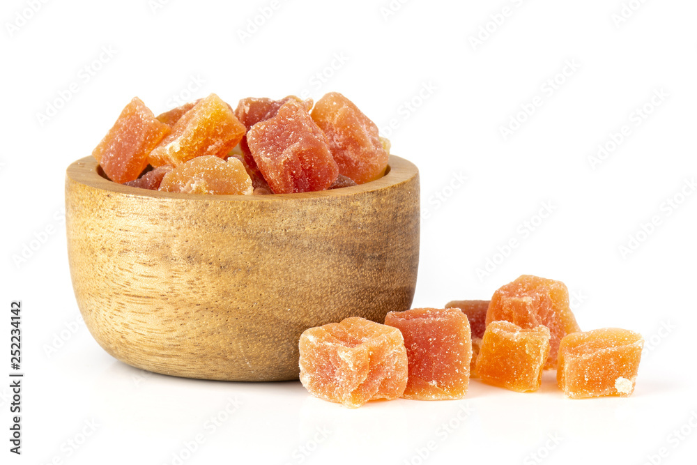 Lot of slices of colorful dry papaya with wooden bowl isolated on white background Lot of slices of colorful dry papaya with wooden bowl isolated on white background