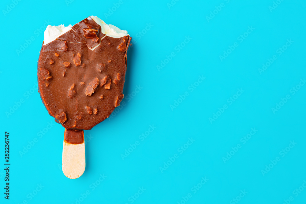 chocolate outer ice cream with peanuts on a blue background with some bites chocolate outer ice cream with peanuts on a blue background with some bites