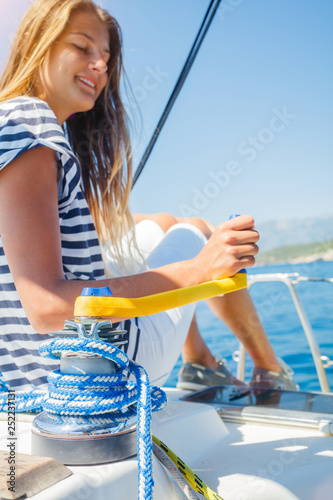 Girl on board of sailing yacht on summer cruise. Travel adventure, yachting with child on family vacation. photo