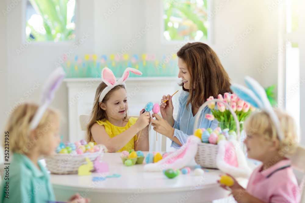 Mother and kids, family coloring Easter eggs. Mother and kids, family coloring Easter eggs.