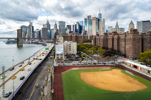 A baseball field along the FDR and East River with views towards the Brooklyn Bridge and Lower Manhattan, New York