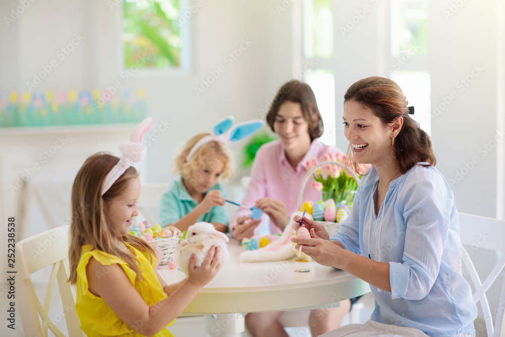Mother and kids, family coloring Easter eggs. Mother and kids, family coloring Easter eggs.
