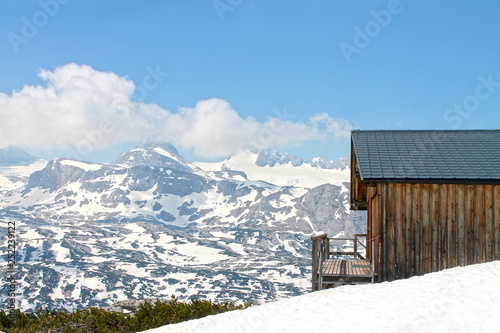 View of Alps and Timber hut in Salzkammergut, Dachstein Krippenstein. Austria. © flycatdesign