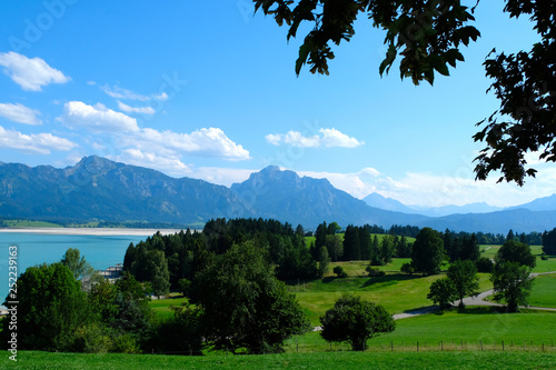 Beautiful Forggensee lake and mountain ranges in Allgäu, Bavaria Germany. Self-drive adventure along the Romantic Road. Lush and green countryside  and driving through a fairy-tale. photo