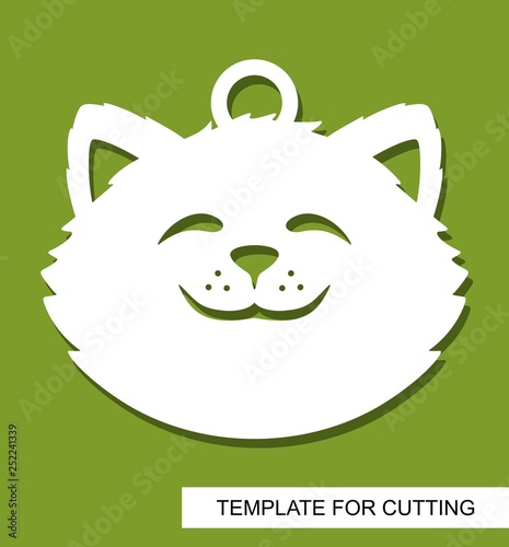 Cat head silhouette. Hanging toy or pendant. White cartoon character on a green background. Template for laser cutting, wood carving, paper cut or printing. Vector illustration.