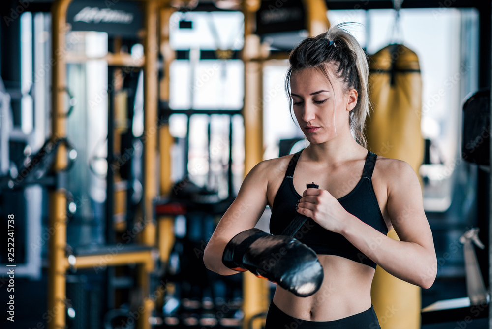 Portrait of a young fighter girl preparing before training. Portrait of a young fighter girl preparing before training.