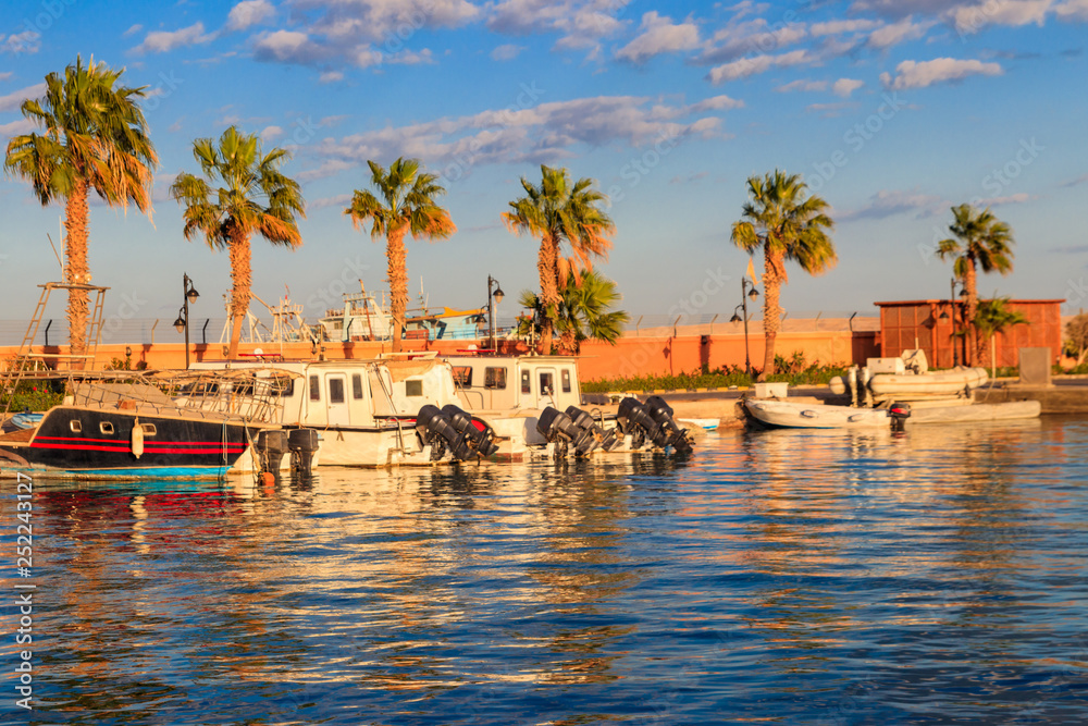 White yachts in the sea harbor of Hurghada, Egypt. Port with tourist boats on the Red Sea White yachts in the sea harbor of Hurghada, Egypt. Port with tourist boats on the Red Sea