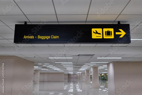 Arrivals baggage claim information board sign international airport terminal