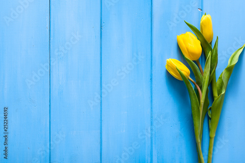 Easter background with spring tulip bouquet on wooden table