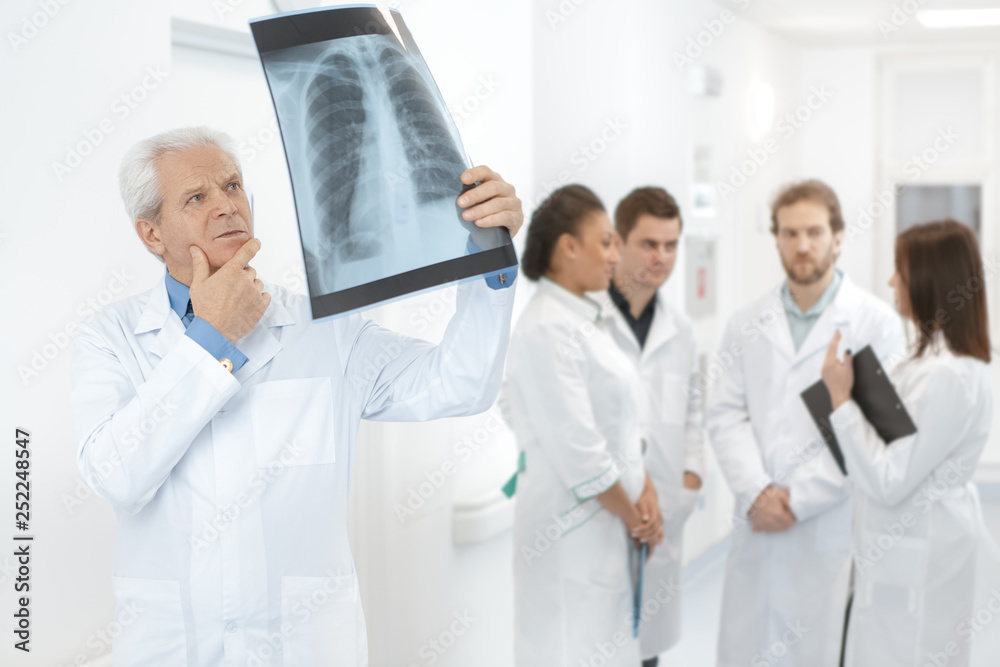 Doctor examining x-ray scan working at the hospital Doctor examining x-ray scan working at the hospital