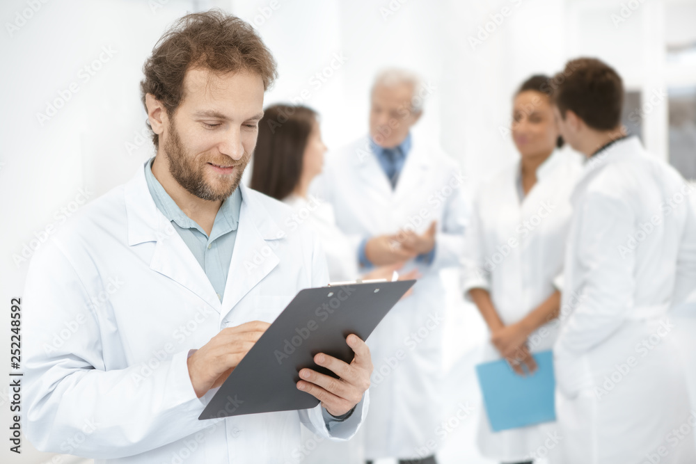 Diverse team of medical professionals standing at the hospital corridor Diverse team of medical professionals standing at the hospital corridor