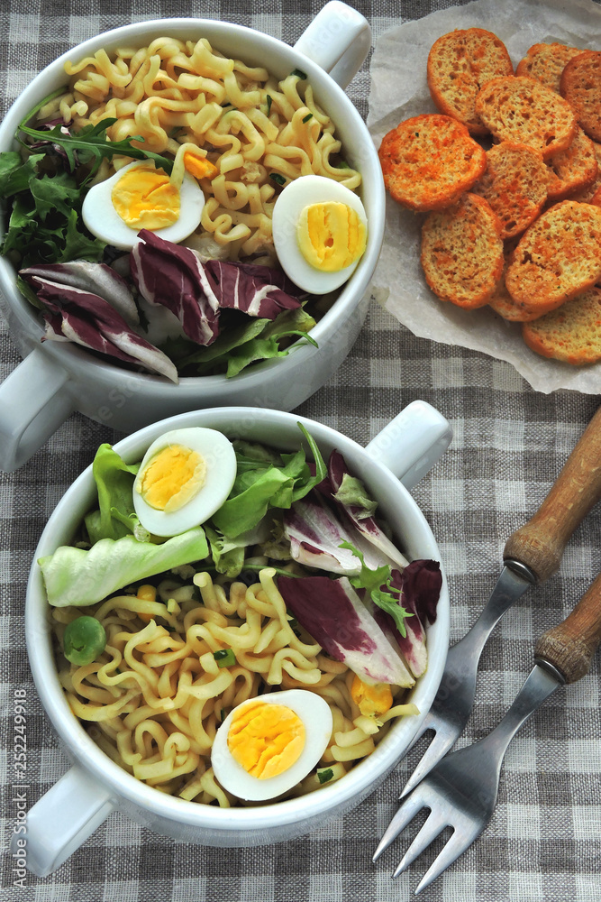 Noodle soup with quail eggs and mix salad
