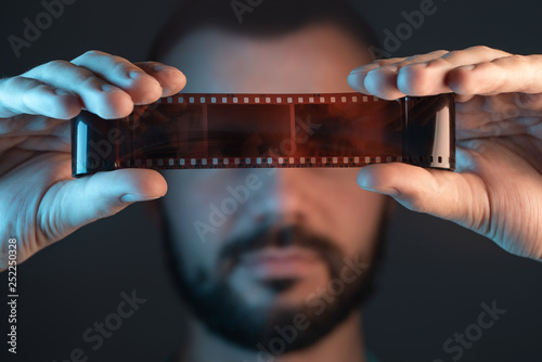 A man checks a film shot after development