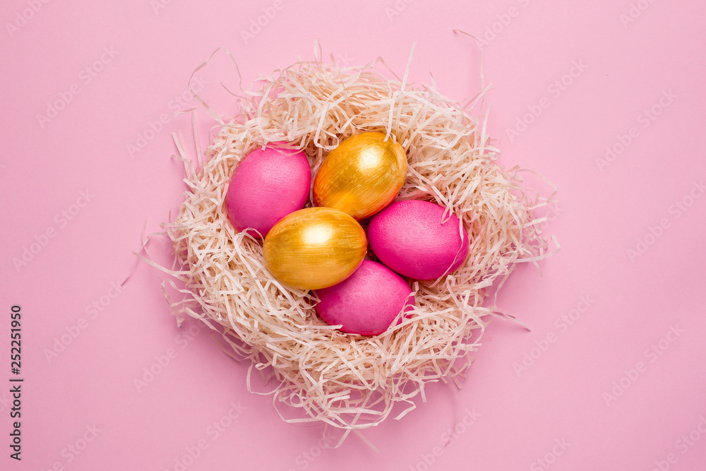 Easter pink and gold eggs on a pink background Easter pink and gold eggs on a pink background