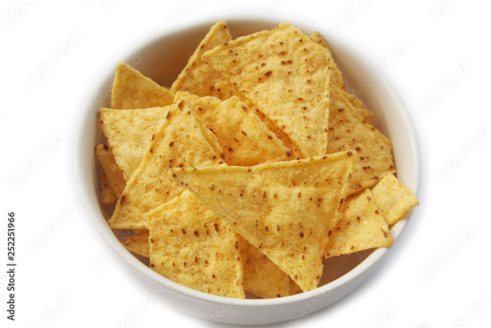 Corn Totillas chips in a bowl isolated on white background. Mexican food also called Nachos
