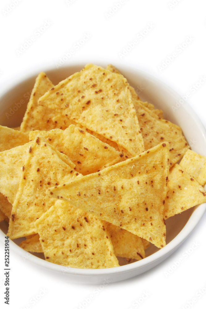 Corn Totillas chips in a bowl isolated on white background. Mexican food also called Nachos Corn Totillas chips in a bowl isolated on white background. Mexican food also called Nachos