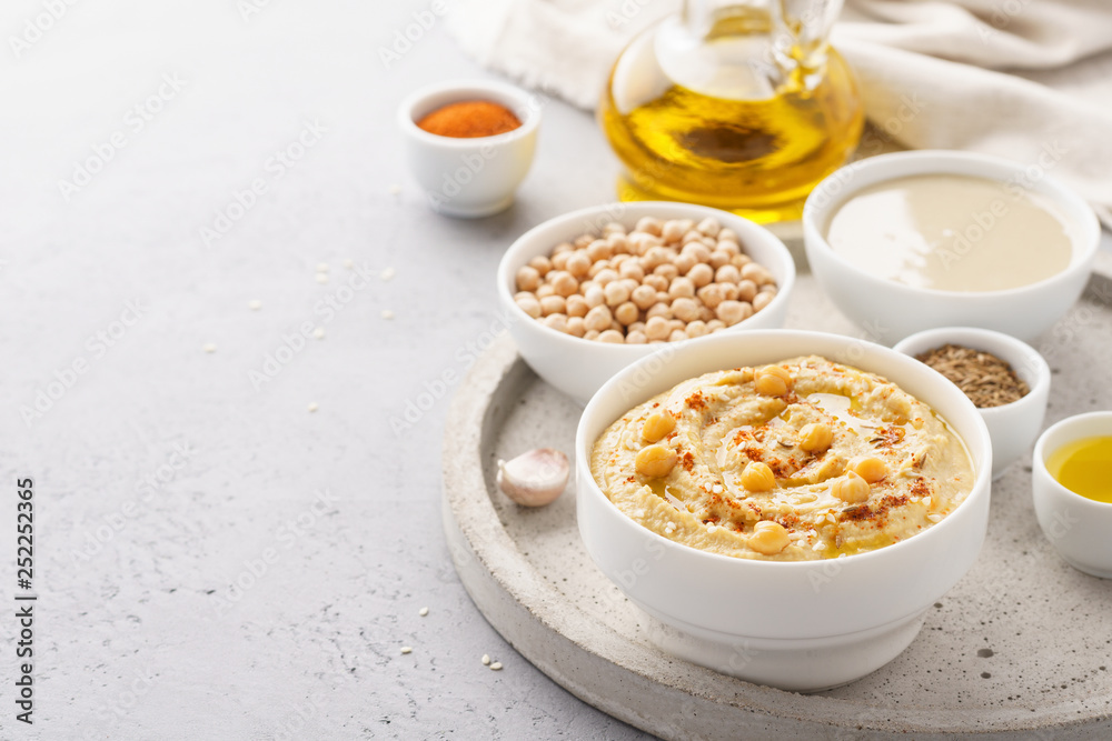 Homemade hummus served with chickpeas, olive oil and paprika. Homemade hummus served with chickpeas, olive oil and paprika.