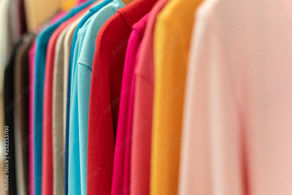 bright colored clothes on a rack bright colored clothes on a rack