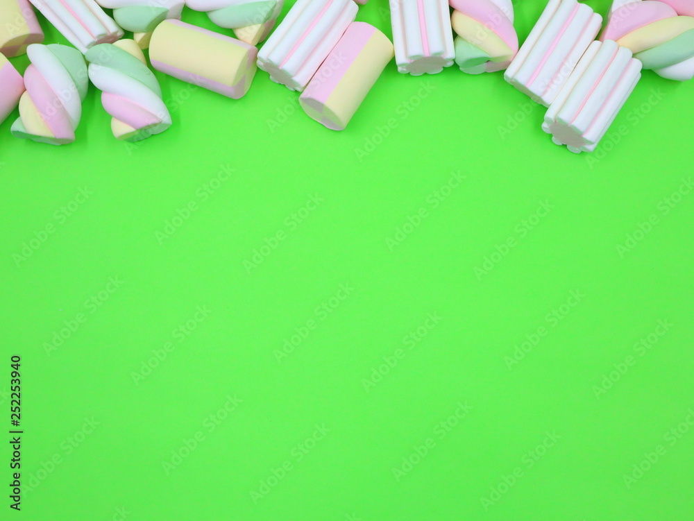 Colorful Marshmallows on green background Colorful Marshmallows on green background