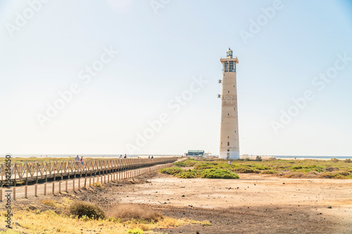 Lighthouse and wooden bridge leading to the beach in Morro Jable  Fuerteventura  Spain