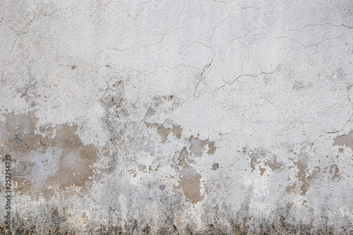 Fototapeta Naklejka Na Ścianę i Meble -  Gray wall ruined by time, bad weather and humidity. Cracks, mold, peeling paint and plaster. Texture, material background.
