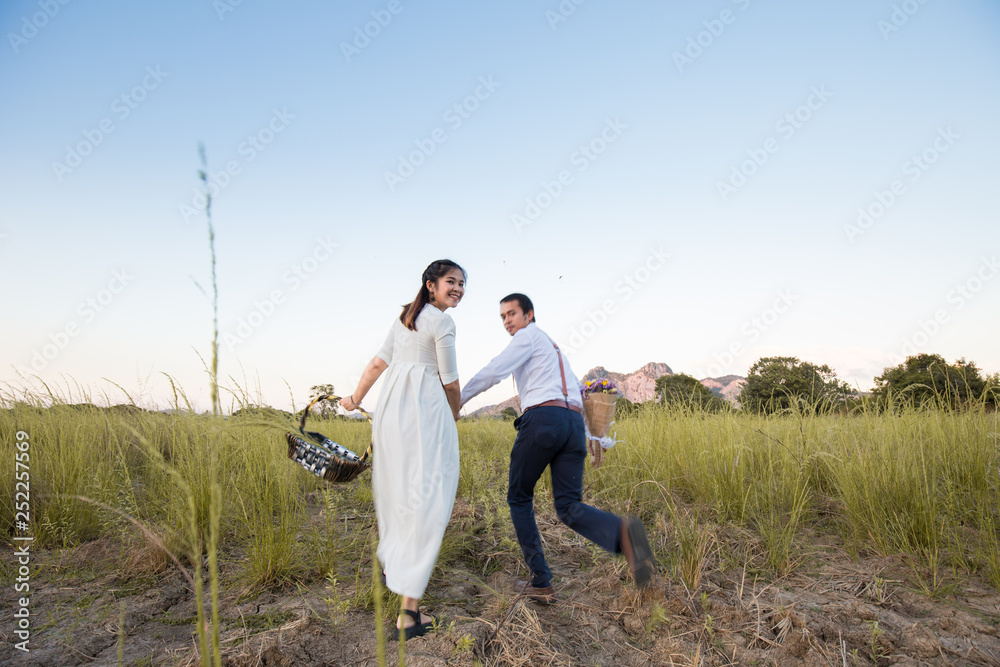 Couple of love running together in green field Couple of love running together in green field