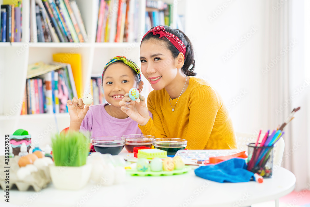 Child and mother showing a painted Easter egg