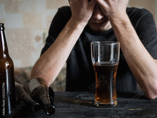 Alcoholism and depression . The concept of drunkenness with grief photo